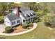 Aerial shot of a charming two-story white home with a well-manicured lawn and landscaping at 935 Amelia Rd, Locust Grove, GA 30248