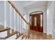 Elegant entryway with hardwood floors, stairs, and a decorative front door at 935 Amelia Rd, Locust Grove, GA 30248
