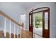 Grand foyer showcasing a beautiful wood door and staircase at 935 Amelia Rd, Locust Grove, GA 30248