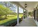 Spacious front porch with classic columns and tranquil views of the surrounding landscape at 935 Amelia Rd, Locust Grove, GA 30248