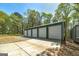 A 4-bay garage featuring roll up doors and concrete apron at 935 Amelia Rd, Locust Grove, GA 30248