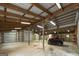 Spacious garage with roll-up doors, ample lighting, and a Kawasaki Mule parked inside at 935 Amelia Rd, Locust Grove, GA 30248