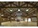 Interior of a large shed featuring a red vehicle, high ceilings, and ample storage at 935 Amelia Rd, Locust Grove, GA 30248