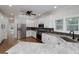 Renovated kitchen features white cabinets, stainless steel appliances, and granite countertops at 935 Amelia Rd, Locust Grove, GA 30248