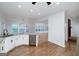 Bright kitchen offers granite counters, stainless appliances, white cabinetry, and hardwood floors at 935 Amelia Rd, Locust Grove, GA 30248