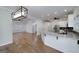 Updated kitchen showcases an island, granite countertops, stainless appliances, and hardwood flooring at 935 Amelia Rd, Locust Grove, GA 30248