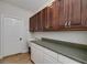 Practical laundry room with ample cabinet space, a utility sink, and an exterior door at 935 Amelia Rd, Locust Grove, GA 30248