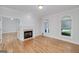 Bright and airy living room featuring hardwood floors, a fireplace, and large windows at 935 Amelia Rd, Locust Grove, GA 30248