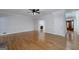 Spacious living room featuring hardwood floors, a ceiling fan, and an open layout at 935 Amelia Rd, Locust Grove, GA 30248