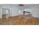 Open-concept living area with hardwood floors and views into the updated kitchen at 935 Amelia Rd, Locust Grove, GA 30248