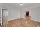 Spacious living room with hardwood floors and a view of the brick fireplace in the next room at 935 Amelia Rd, Locust Grove, GA 30248