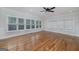 Bright living room with hardwood flooring, crown moulding and ample natural light from large windows at 935 Amelia Rd, Locust Grove, GA 30248