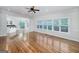 Open living space with hardwood floors, view to the kitchen, and lots of natural light at 935 Amelia Rd, Locust Grove, GA 30248