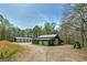 Large garages on property with multiple bays and gravel driveway at 935 Amelia Rd, Locust Grove, GA 30248
