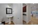 Charming powder room with a pedestal sink and a view into the kitchen at 935 Amelia Rd, Locust Grove, GA 30248