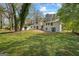 Spacious backyard view showcasing well-kept lawn, mature trees, and an auxiliary structure for storage or hobbies at 1146 Redan Way, Stone Mountain, GA 30088