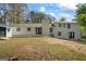 Backyard featuring a stone fireplace, black frame windows, and a well-maintained yard, perfect for outdoor gatherings at 1146 Redan Way, Stone Mountain, GA 30088