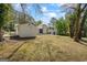 Backyard view featuring mature trees, and an auxiliary structure for storage or hobbies, with ample space for recreation at 1146 Redan Way, Stone Mountain, GA 30088