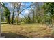 A large backyard with mature trees, defined by a partial fence at 1146 Redan Way, Stone Mountain, GA 30088