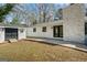 Backyard view featuring a patio, a stone fireplace, and an auxiliary structure for storage or hobbies at 1146 Redan Way, Stone Mountain, GA 30088