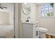 Updated bathroom features a modern vanity, mirror, and fixtures, adjacent to a bright bedroom at 1146 Redan Way, Stone Mountain, GA 30088