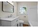 Updated bathroom with modern vanity, fixtures, and a shower-tub combo at 1146 Redan Way, Stone Mountain, GA 30088