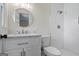 Updated bathroom features a white vanity, round mirror, tiled shower, and updated fixtures at 1146 Redan Way, Stone Mountain, GA 30088