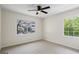 Empty bedroom with carpet, ceiling fan and two large windows with wooded view at 1146 Redan Way, Stone Mountain, GA 30088