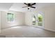 Carpeted bedroom with ceiling fan and a glass patio door leading to the back yard at 1146 Redan Way, Stone Mountain, GA 30088