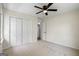 Bedroom featuring neutral carpet, closet, ceiling fan and view to the backyard at 1146 Redan Way, Stone Mountain, GA 30088