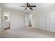 Bright bedroom features neutral carpet, a ceiling fan, closet, and an ensuite bathroom at 1146 Redan Way, Stone Mountain, GA 30088