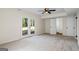 Carpeted bedroom with ceiling fan and a glass patio door leading to the back yard at 1146 Redan Way, Stone Mountain, GA 30088