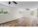 Spacious bedroom with windows providing natural light, beautiful hardwood flooring, and a ceiling fan at 1146 Redan Way, Stone Mountain, GA 30088