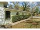 Welcoming front entrance with a covered porch, arched openings, and a well-maintained hedge for added privacy at 1146 Redan Way, Stone Mountain, GA 30088