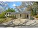 Inviting exterior view featuring a covered parking area, an archway entrance, and lush greenery, enhancing its charm at 1146 Redan Way, Stone Mountain, GA 30088