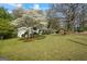 Eye-catching exterior with a manicured lawn, blossoming trees, and a covered parking area, perfect for outdoor enjoyment at 1146 Redan Way, Stone Mountain, GA 30088