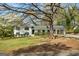 Charming home with landscaped front yard, covered parking, and black framed windows, creating a welcoming curb appeal at 1146 Redan Way, Stone Mountain, GA 30088