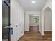 Hallway featuring wood flooring, white trim, and an arched doorway at 1146 Redan Way, Stone Mountain, GA 30088