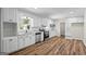 Modern kitchen features stainless steel appliances, white cabinets, and hardwood flooring at 1146 Redan Way, Stone Mountain, GA 30088