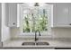 Close-up of a kitchen sink with a view to the wooded backyard at 1146 Redan Way, Stone Mountain, GA 30088