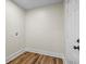 Small laundry room with washer hookup, wood-look flooring and white door at 1146 Redan Way, Stone Mountain, GA 30088