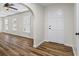 Open-concept living room features wood flooring, white trim, and modern ceiling fan at 1146 Redan Way, Stone Mountain, GA 30088