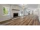 Open living room featuring fireplace, hardwood flooring, chandelier, and stainless steel appliances at 1146 Redan Way, Stone Mountain, GA 30088