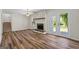 Open living room with a stone fireplace and doors to the outside at 1146 Redan Way, Stone Mountain, GA 30088