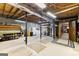 Unfinished basement with exposed ceiling, concrete flooring, laundry area, and utility systems at 1407 Highway 92 N, Fayetteville, GA 30214