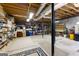 Spacious unfinished basement with exposed ceiling and shelves stocked with storage containers at 1407 Highway 92 N, Fayetteville, GA 30214