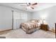 Comfortable bedroom with a ceiling fan, a window with curtains, and carpet flooring at 1407 Highway 92 N, Fayetteville, GA 30214