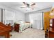Bright bedroom with a cozy daybed, a study desk, and a window with sheer curtains at 1407 Highway 92 N, Fayetteville, GA 30214