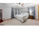 Bedroom features plush carpeting, natural light, ceiling fan and neutral paint at 1407 Highway 92 N, Fayetteville, GA 30214