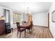 Open and spacious dining room with decorative chandelier and ample natural lighting at 1407 Highway 92 N, Fayetteville, GA 30214